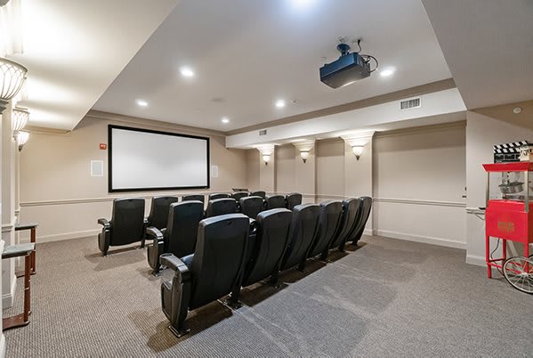 A cozy home theater setup with a projector and comfortable seating.
