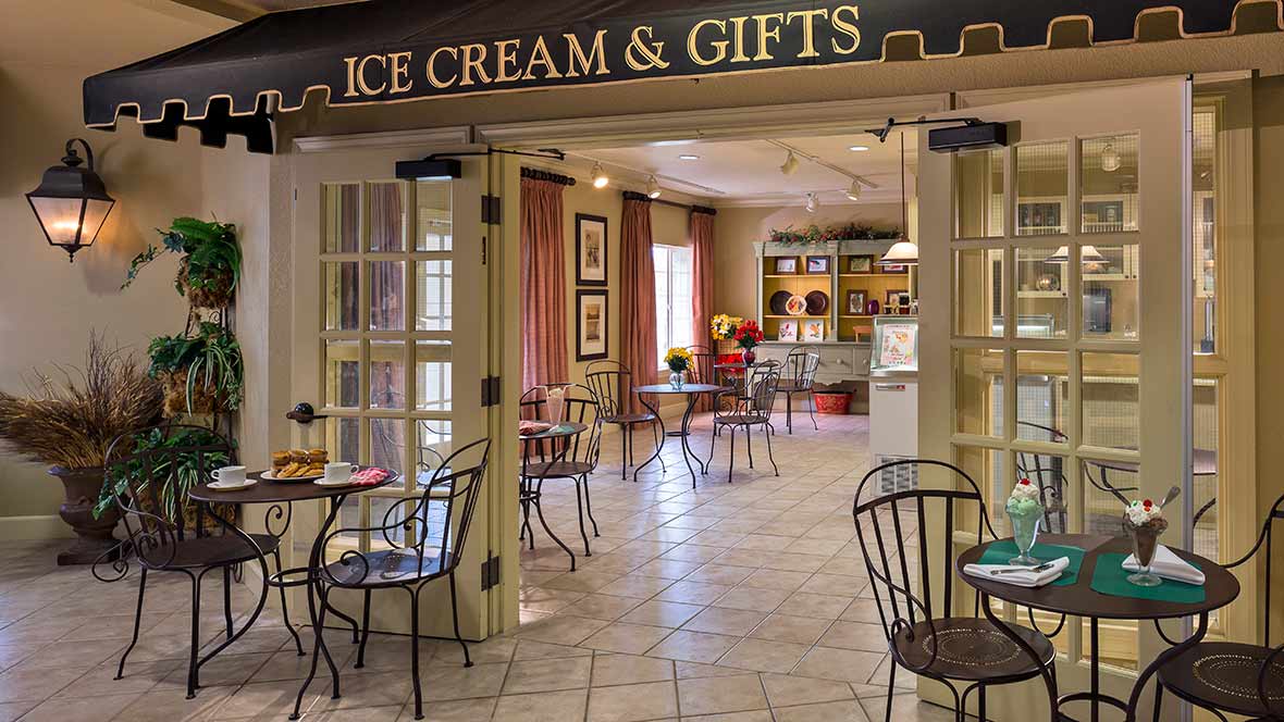 A cozy ice cream and gift shop with inviting tables and chairs.