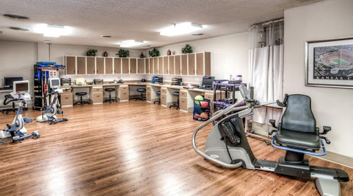 A spacious fitness area equipped with various exercise machines, designed for rehabilitation and health improvement.
