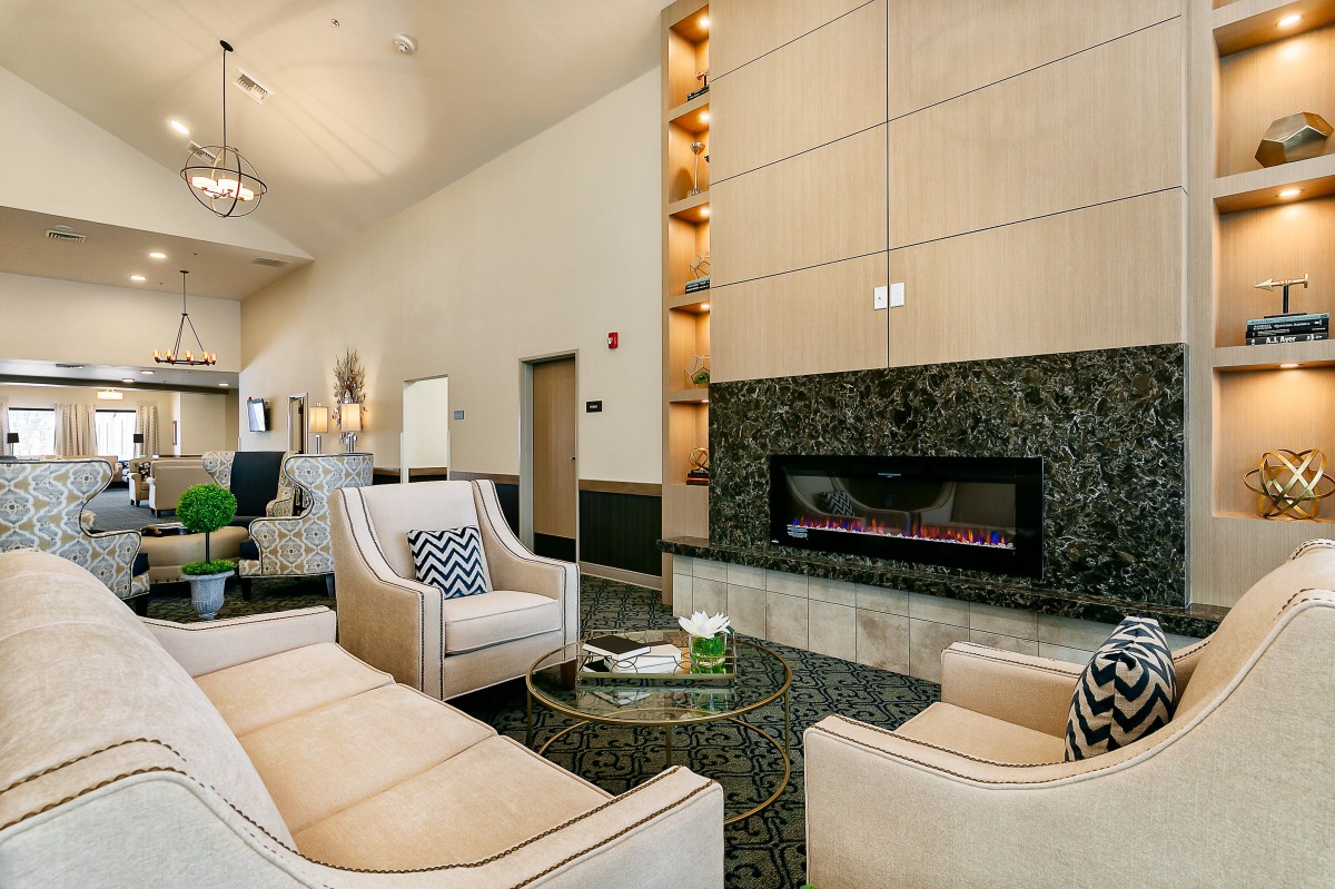 A modern lounge area with comfortable seating and a sleek fireplace.
