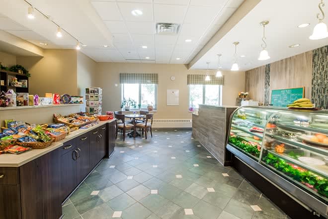 Interior view of a cafe with a buffet and seating area.