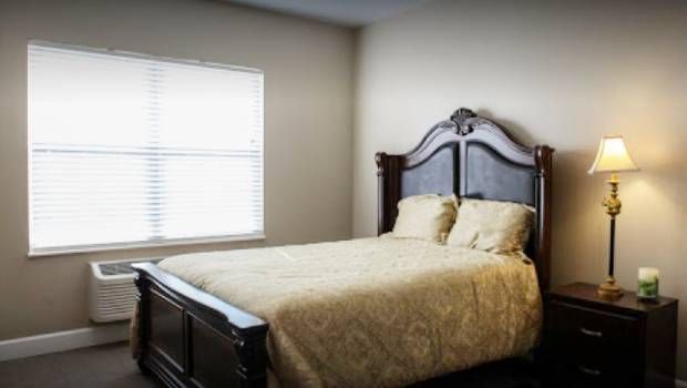 A well-appointed bedroom with a large bed and elegant headboard.