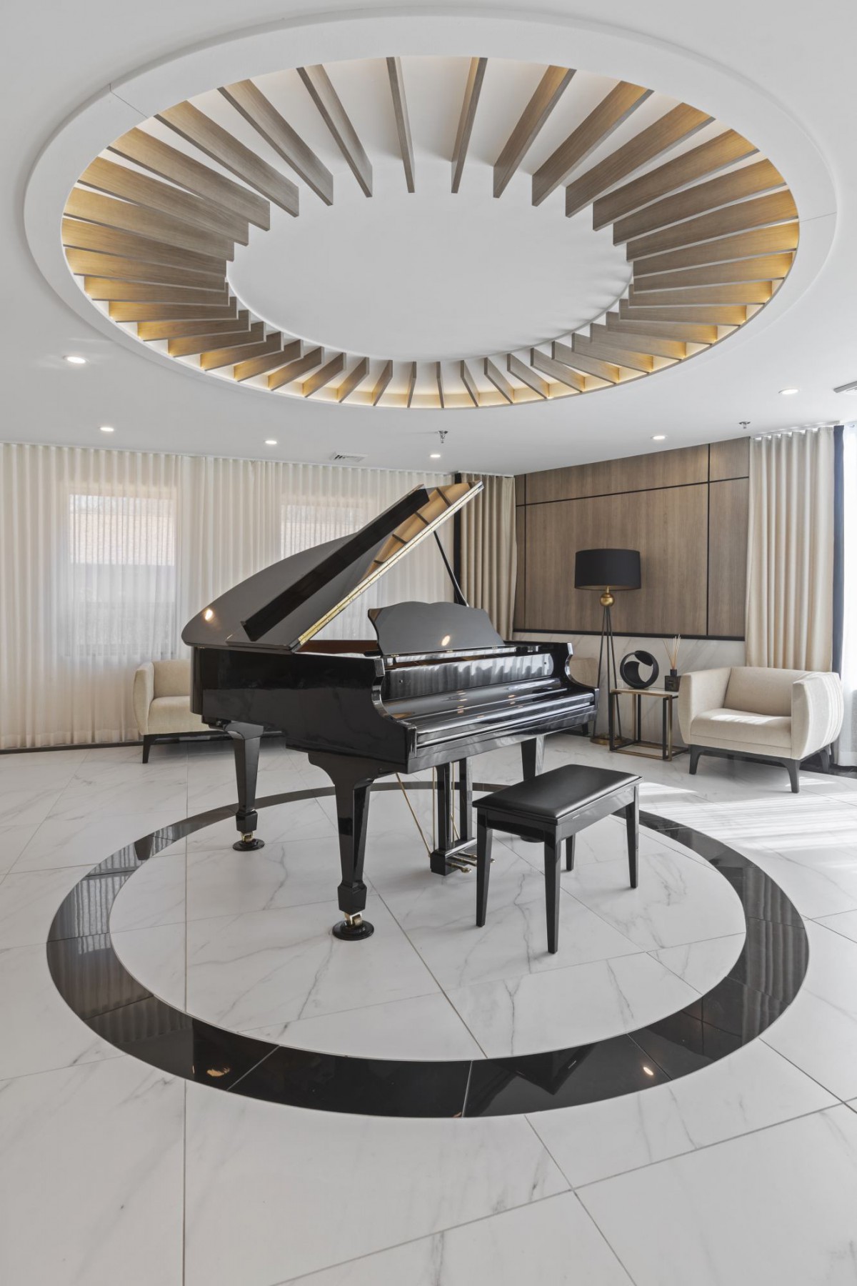 A luxurious living room featuring a grand piano in an elegant and modern setting.