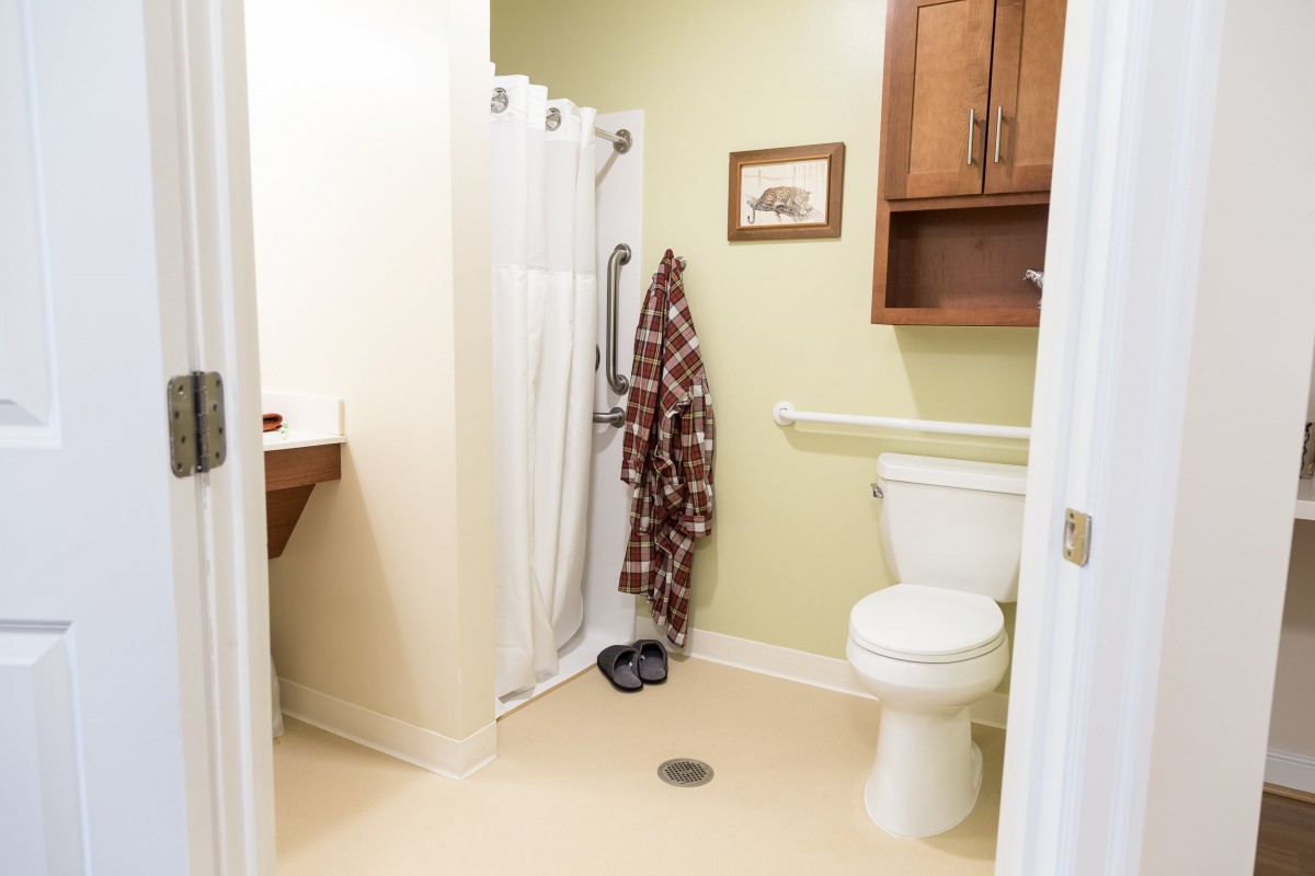 A clean bathroom with a shower, toilet, and sink.
