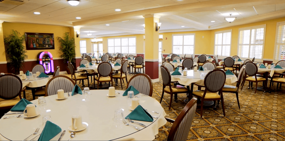 An elegant dining room with neatly arranged tables and chairs.