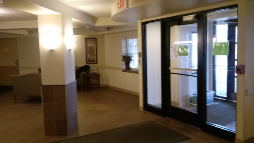 A view of the lobby entrance with a seating area and natural light.
