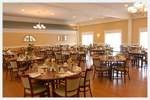 A cozy dining room with neatly arranged tables and chairs.