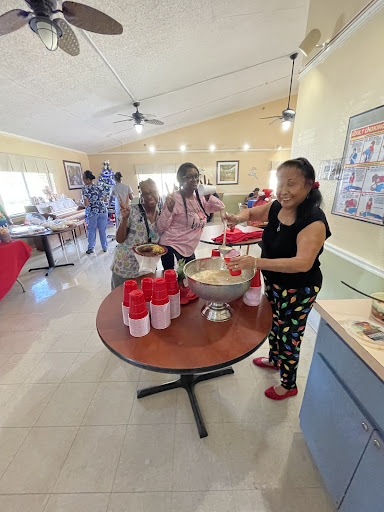 A lively community gathering where people are enjoying food and socializing.