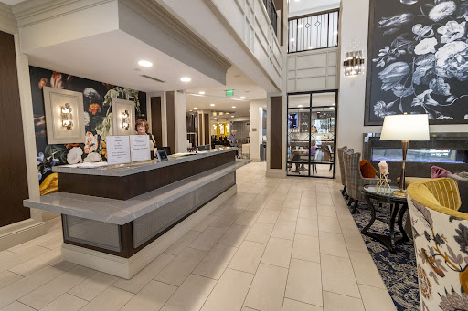 A spacious and modern hotel lobby featuring a reception desk and stylish seating arrangements.