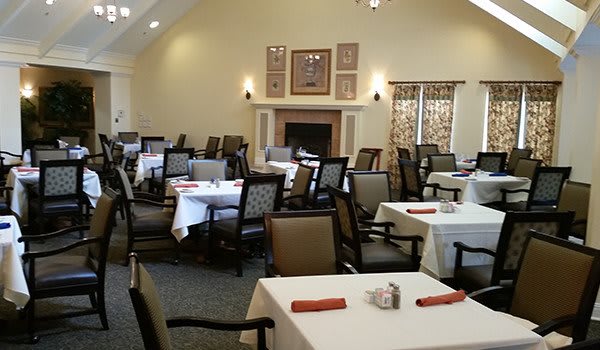 A well-arranged dining room with multiple tables and chairs, ready for guests.