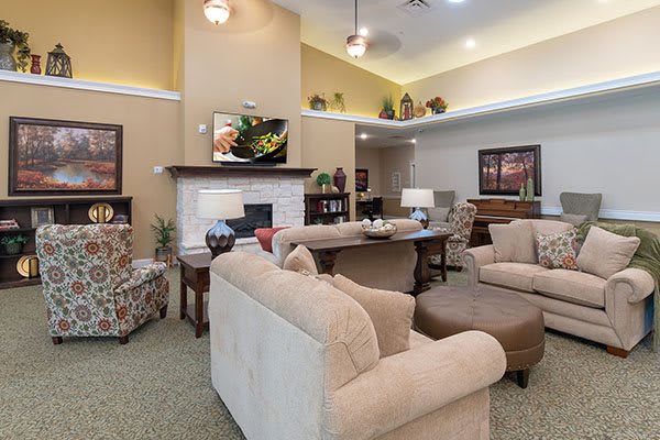 A cozy living room with comfortable seating and a fireplace.