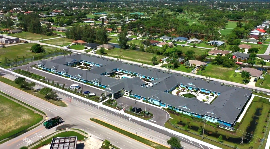 Aerial view of a residential complex surrounded by greenery.