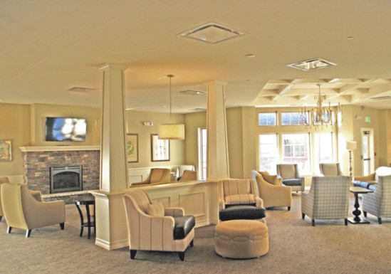 A cozy lobby with comfortable seating, a fireplace, and elegant lighting.