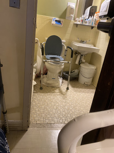 An accessible bathroom equipped with a toilet and sink.
