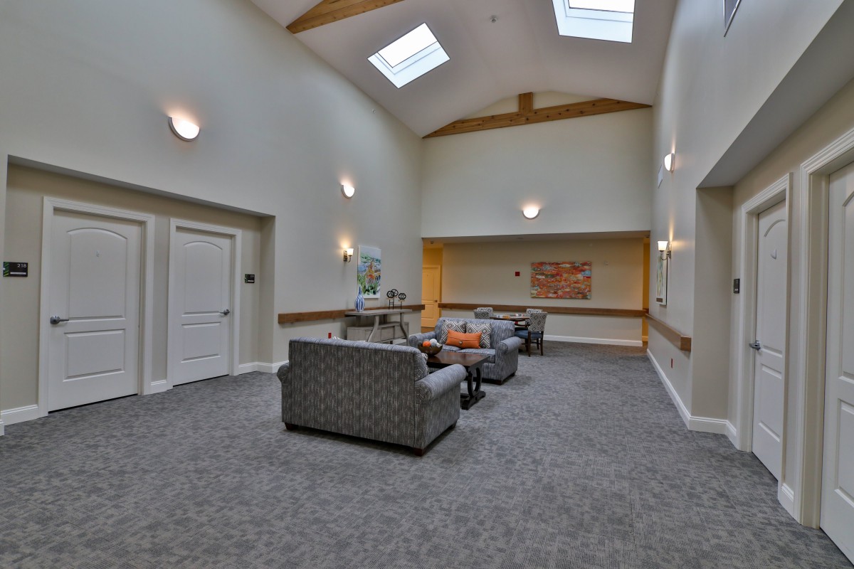 A modern lounge area featuring comfortable seating and skylights, creating a bright and inviting atmosphere.