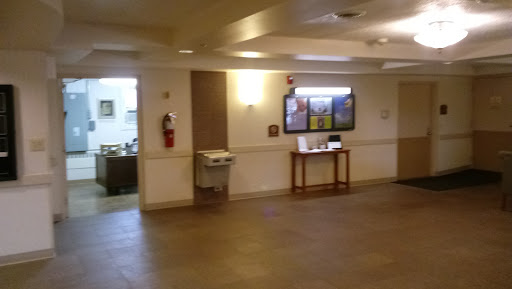 A view of a lobby area featuring a water fountain and informational displays.