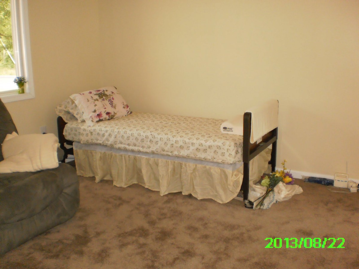 A simple bedroom with a single bed and minimal decor.