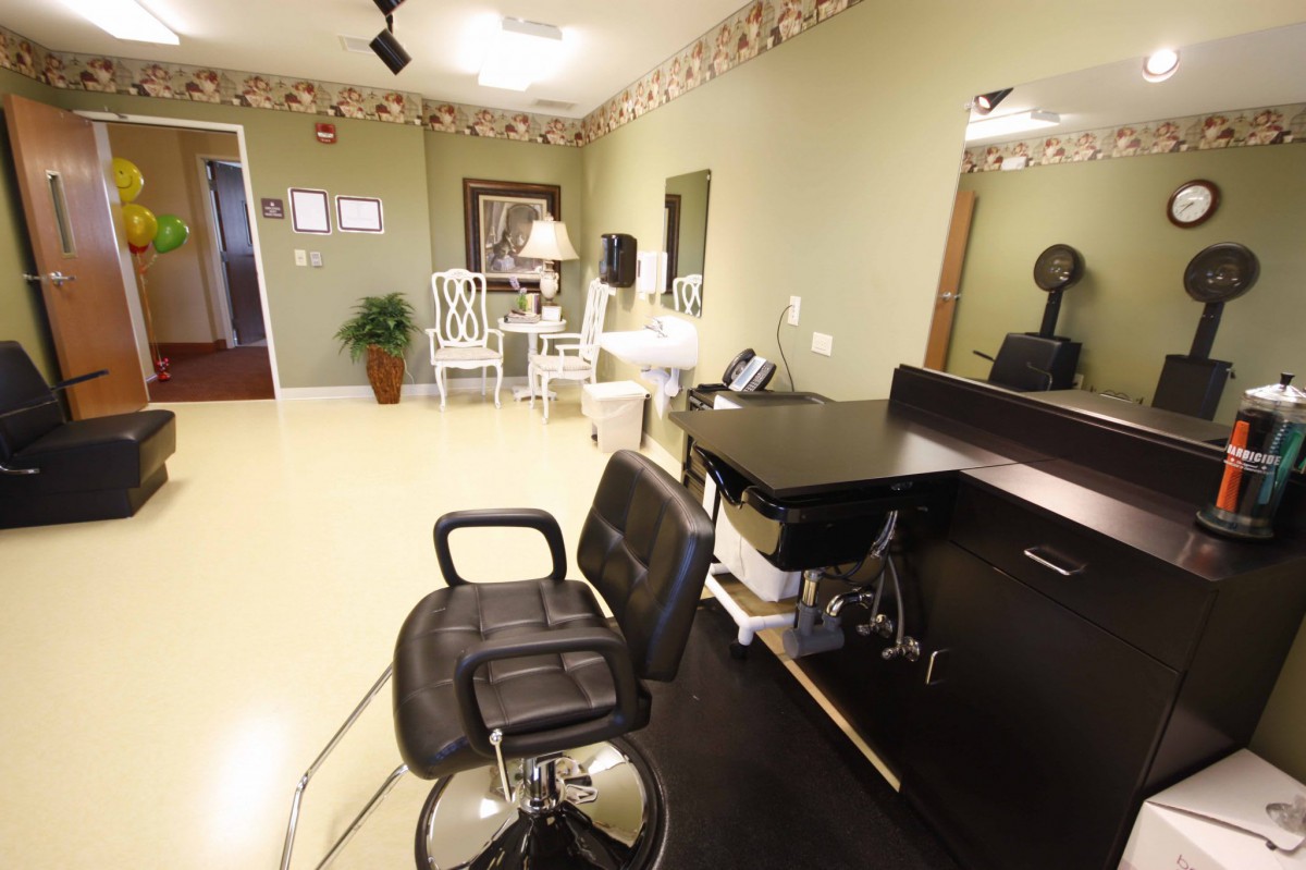 A modern hair salon interior featuring styling chairs and mirrors.