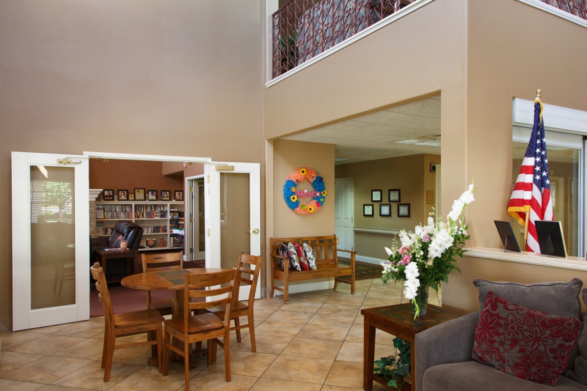 A cozy lobby area with seating, a table, and decorative elements.