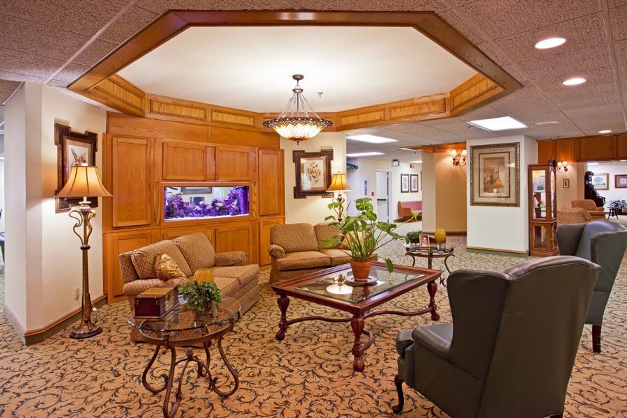 A cozy lobby area with comfortable seating, a fish tank, and elegant decor.