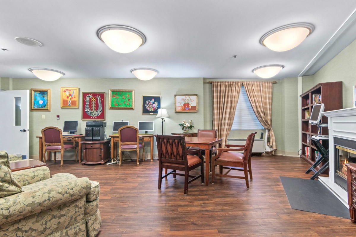 A cozy lounge area with computers, tables, and comfortable seating.