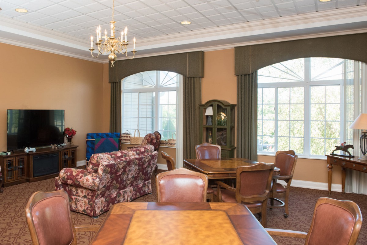 A cozy living room with elegant furniture and large windows.