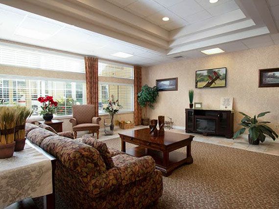 A cozy and spacious living room with ample natural light, featuring comfortable furniture and elegant decor.