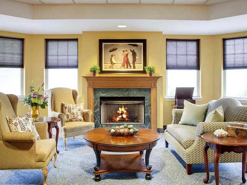 A cozy living room with a fireplace, elegant furniture, and tasteful decor.
