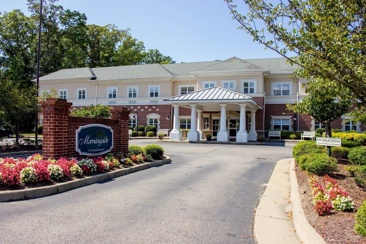 A well-maintained building with a welcoming entrance and landscaped surroundings.