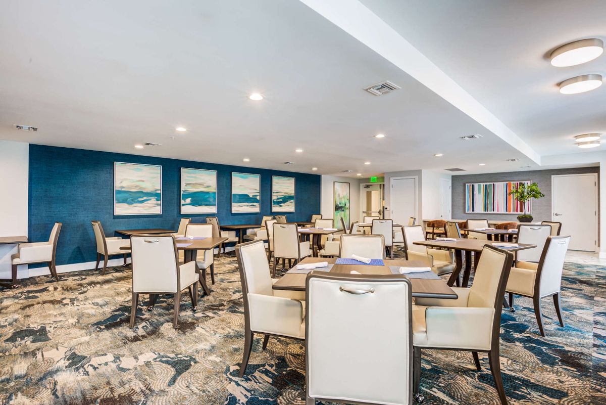 A modern dining area with neatly arranged tables and elegant interior design.