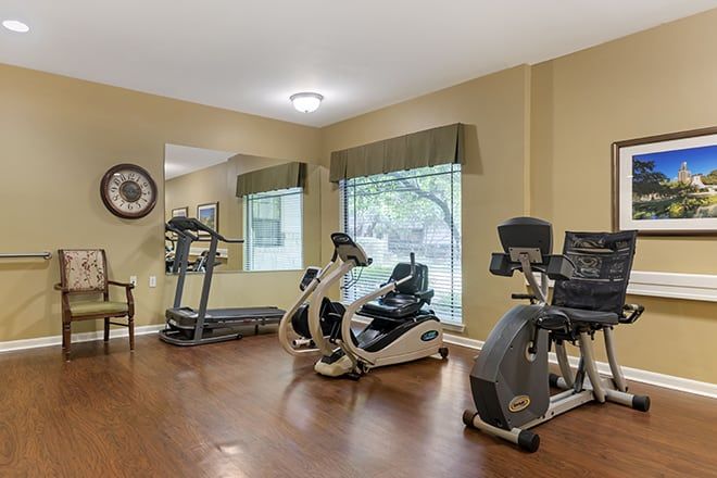A modern gym equipped with treadmills and stationary bikes.