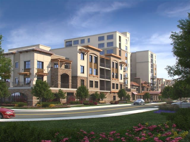 A modern apartment complex with multi-story buildings and landscaped surroundings.