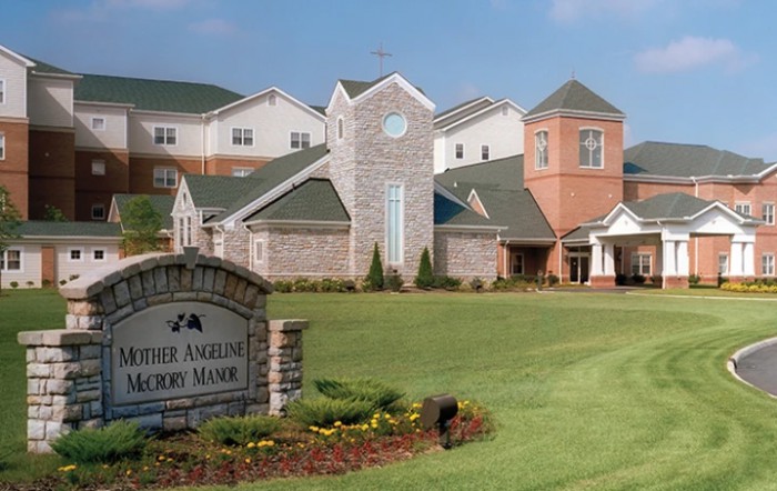 A well-maintained church building surrounded by green lawns and landscaping.