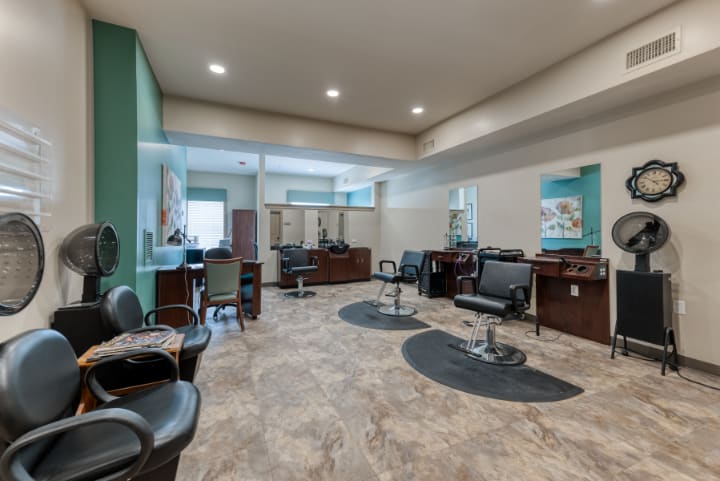 A modern hair salon with styling stations and comfortable seating.