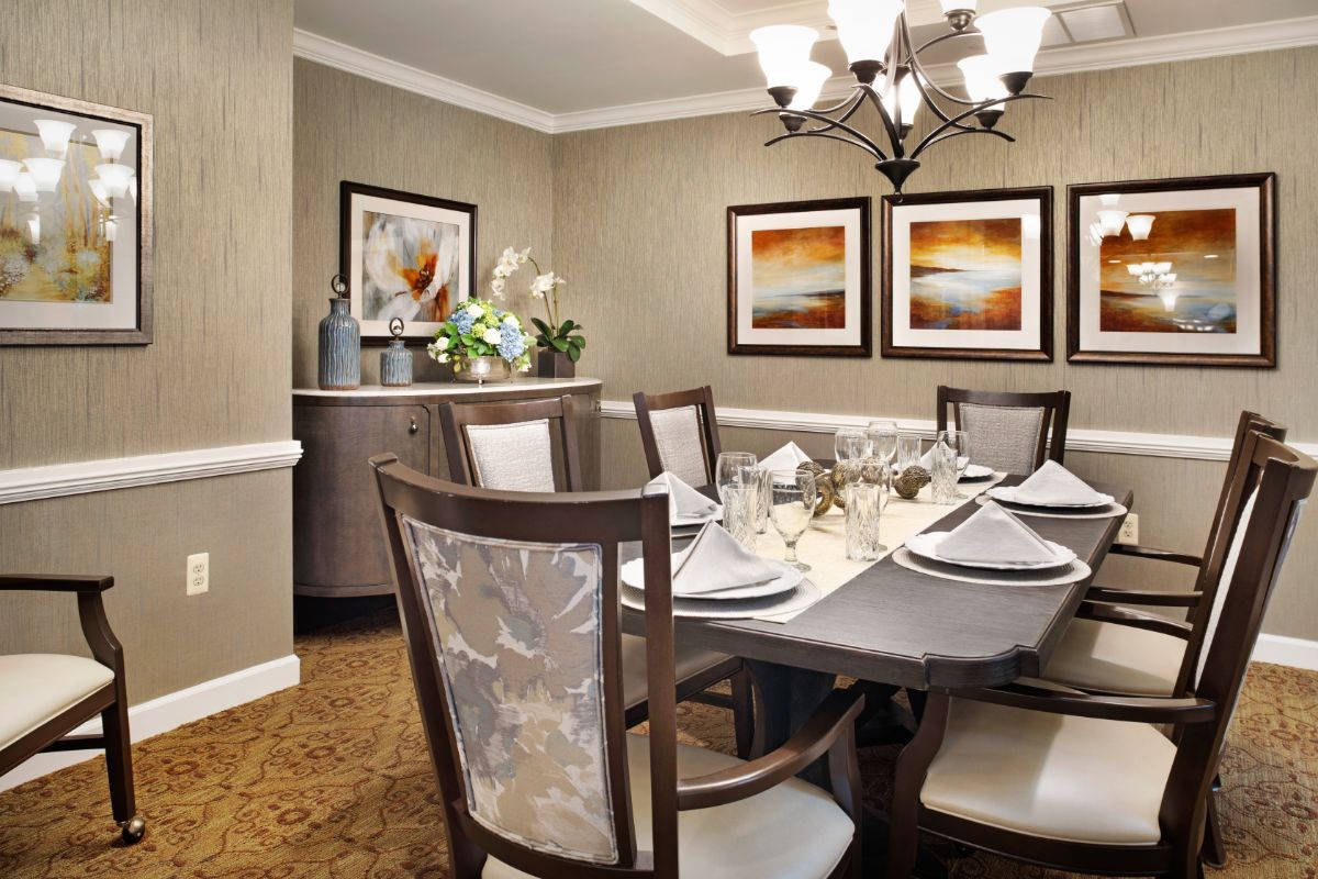 An elegantly arranged dining room with a sophisticated table setting and tasteful decor.