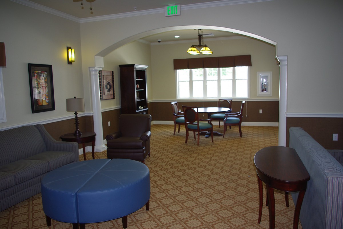 A cozy lounge area with comfortable seating and a table near the window.