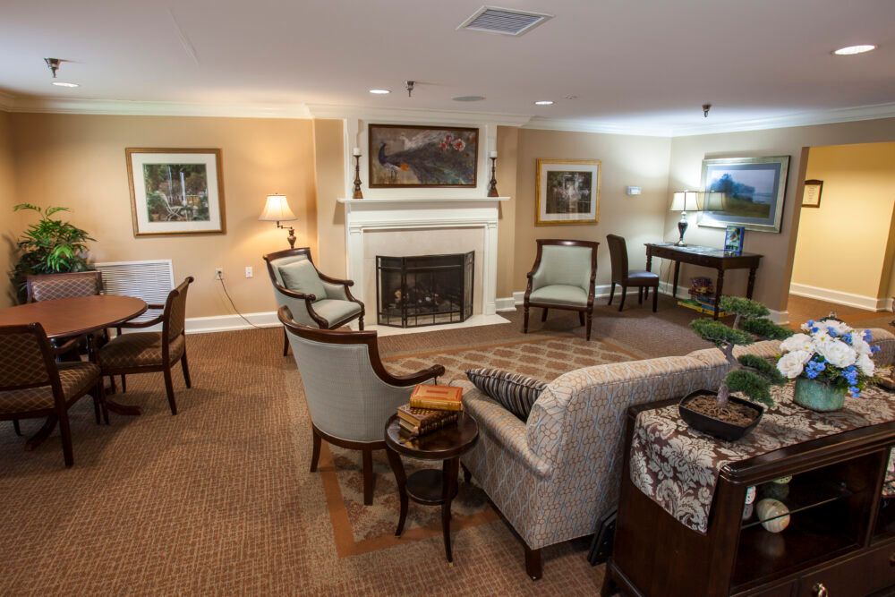 A cozy living room featuring a fireplace, comfortable seating, and elegant decor.