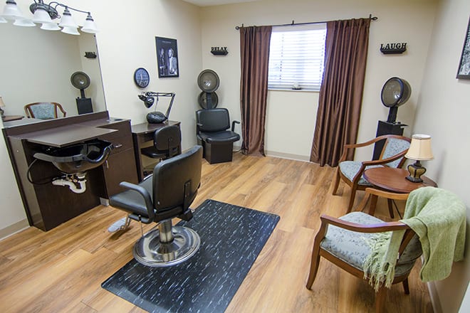 A cozy hair salon with styling chairs, mirrors, and a wooden floor.
