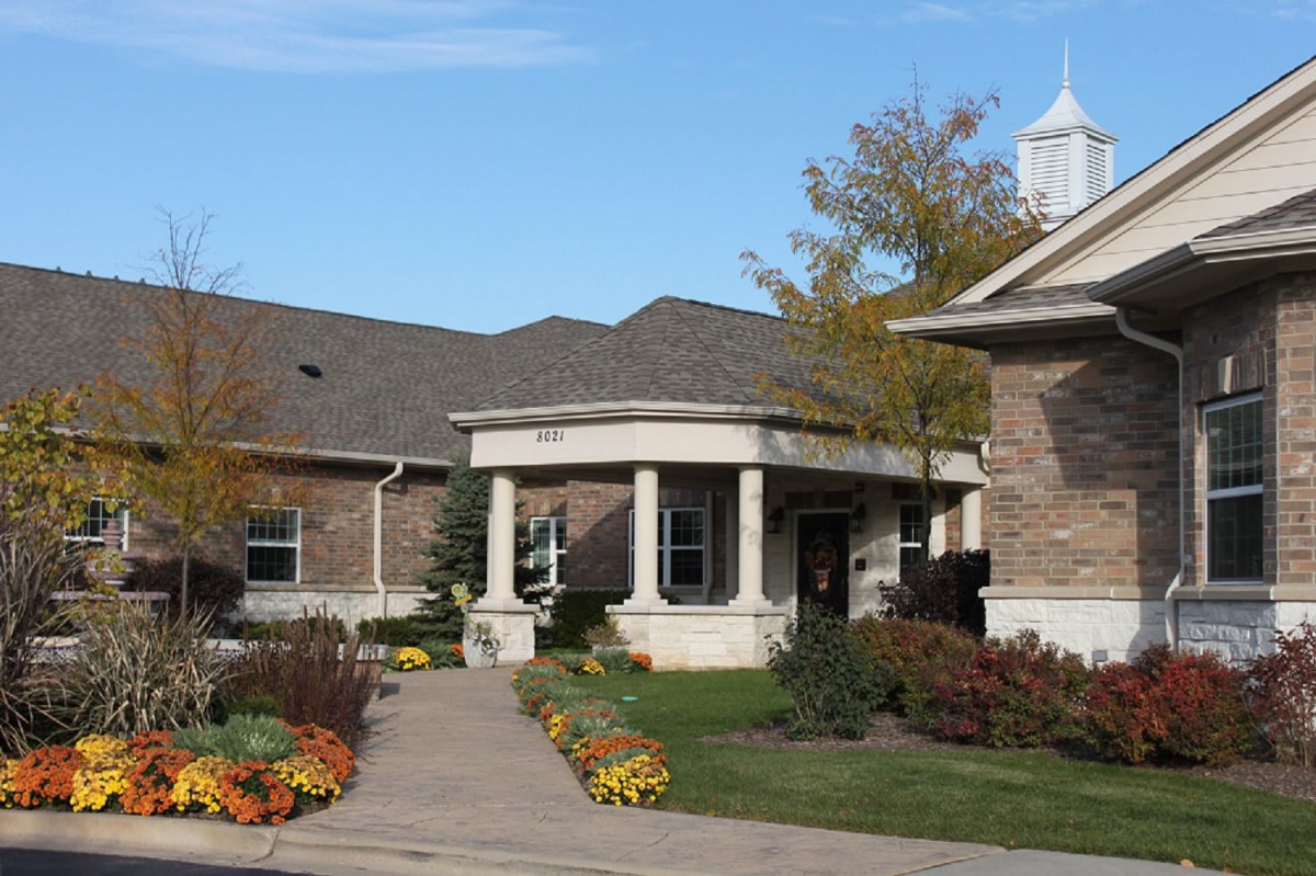 A building with a landscaped garden and an entrance walkway.