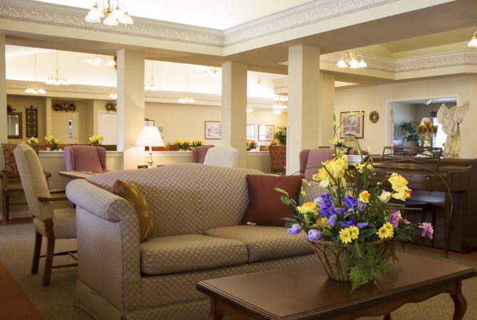 A cozy living room with a comfortable sofa and floral arrangement on the coffee table.
