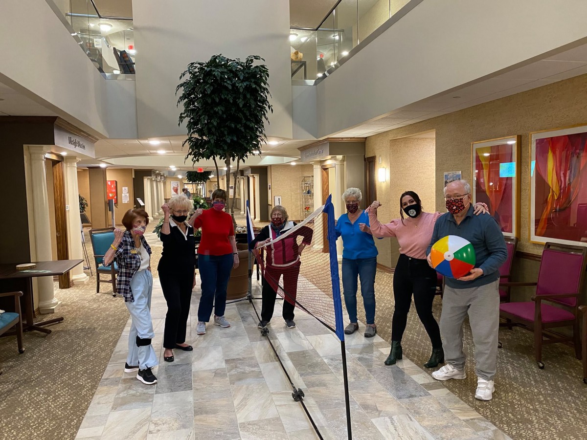 A group of people enjoying an indoor game activity together.