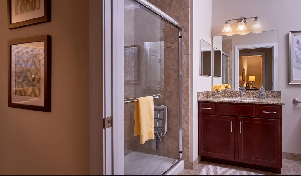 Modern bathroom with a glass-enclosed shower and vanity.