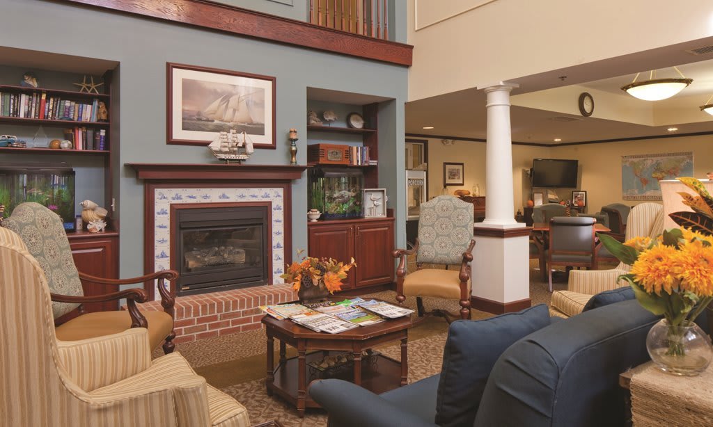 A cozy living room with a fireplace and comfortable seating.