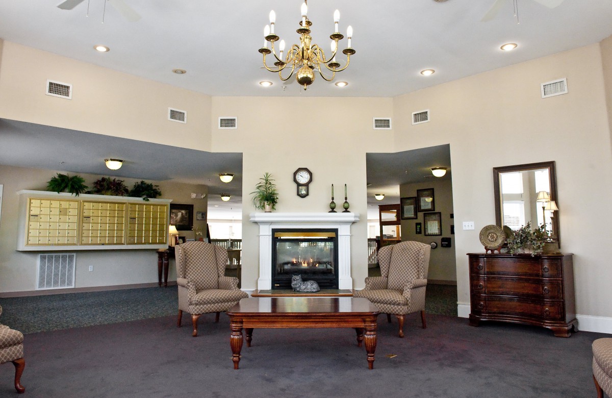 A cozy lobby with elegant furniture and a chandelier.