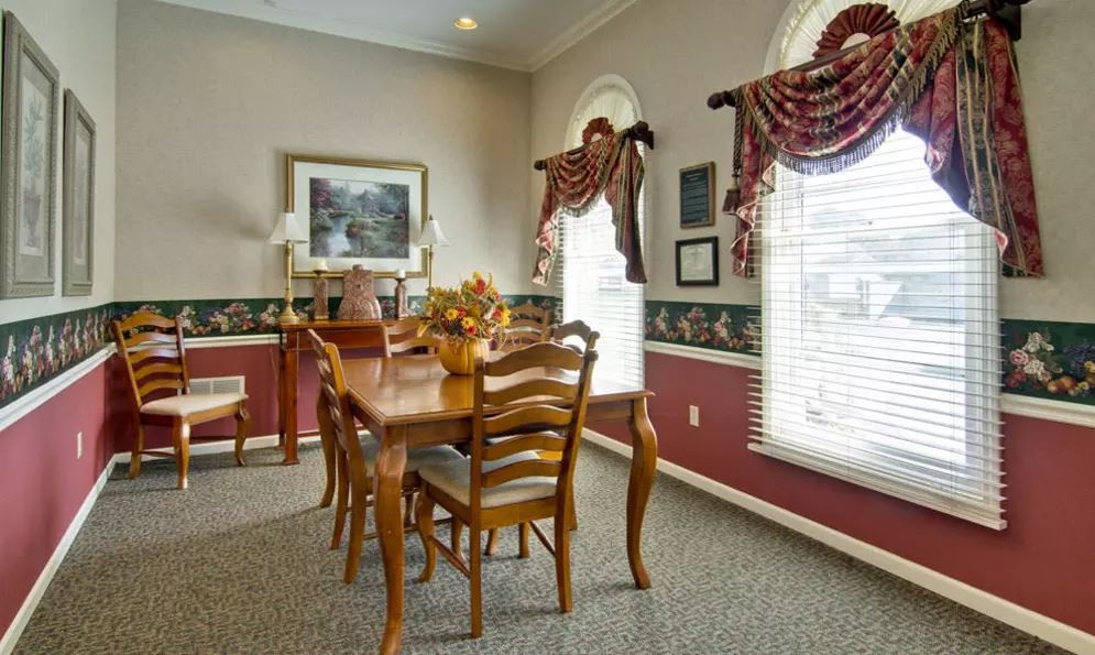 A classic dining room featuring wooden furniture and elegant curtains.