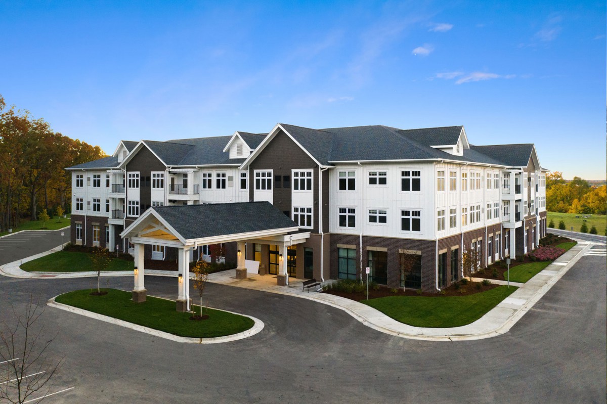 A modern residential building with a welcoming entrance, captured during the daytime.
