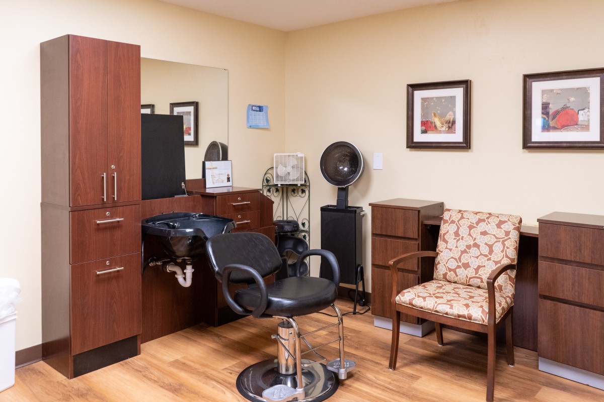 A well-organized hair salon interior with styling chair and equipment.