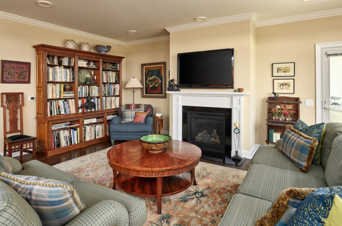 Cozy living room with a bookshelf and fireplace.