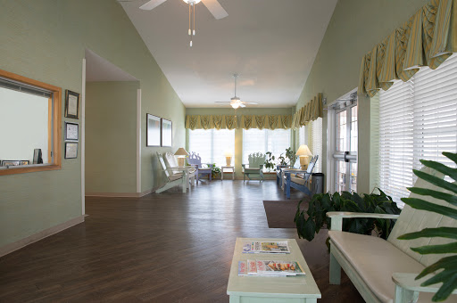 A bright and inviting living room with ample natural light, comfortable seating, and a peaceful ambiance.
