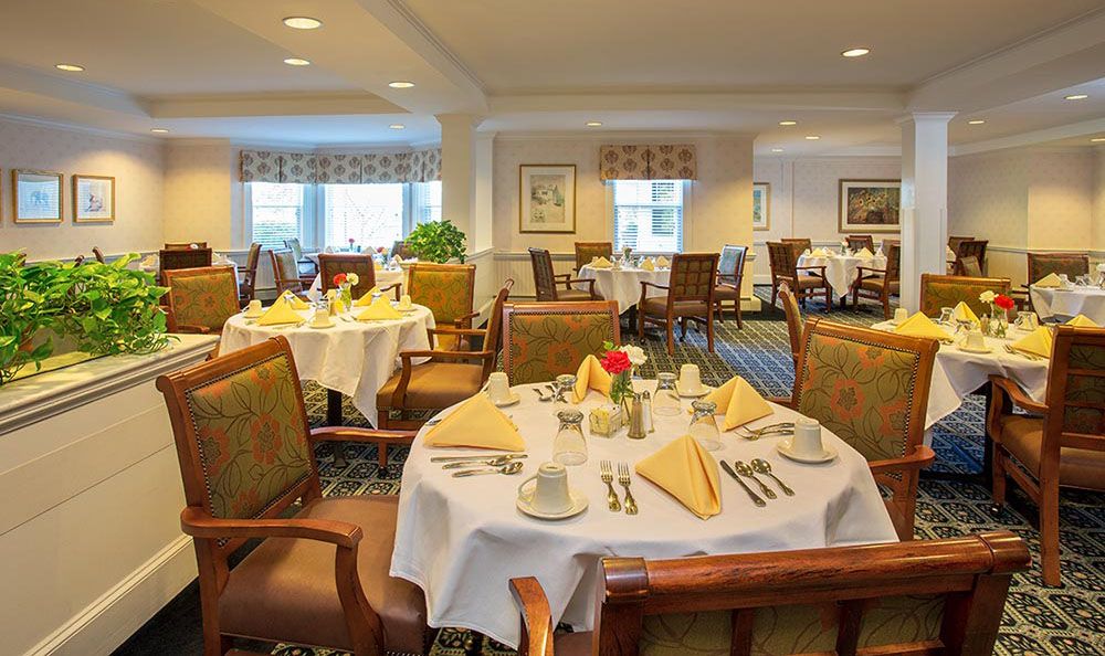 An elegant dining room with neatly arranged tables and chairs, ready for guests.